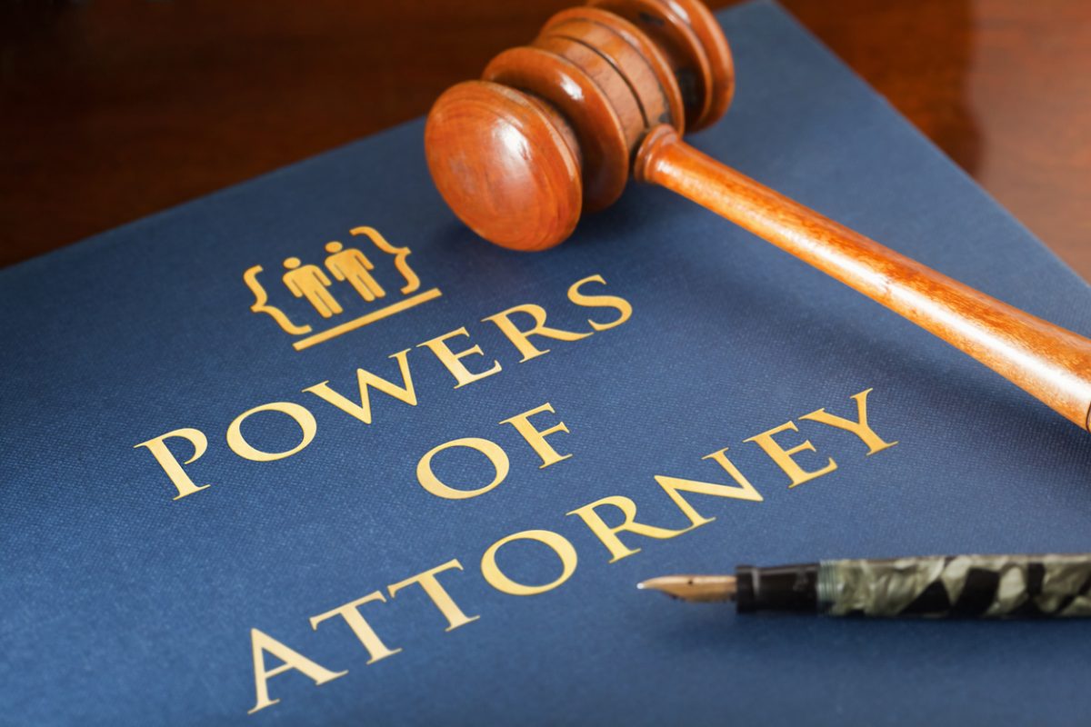 Gavel laying across a book entitled Powers of Attorney