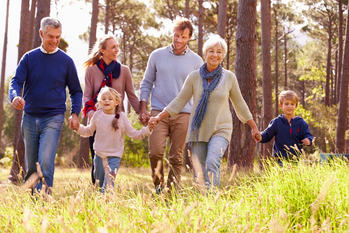 Multi-generational family walking in woods