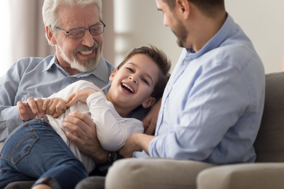 Grandad, Dad, and child playing on the sofa