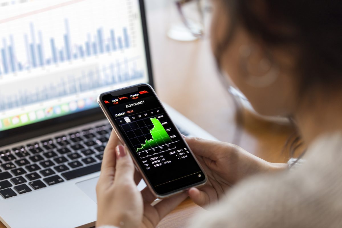 Woman looking at stocks on her mobile phone