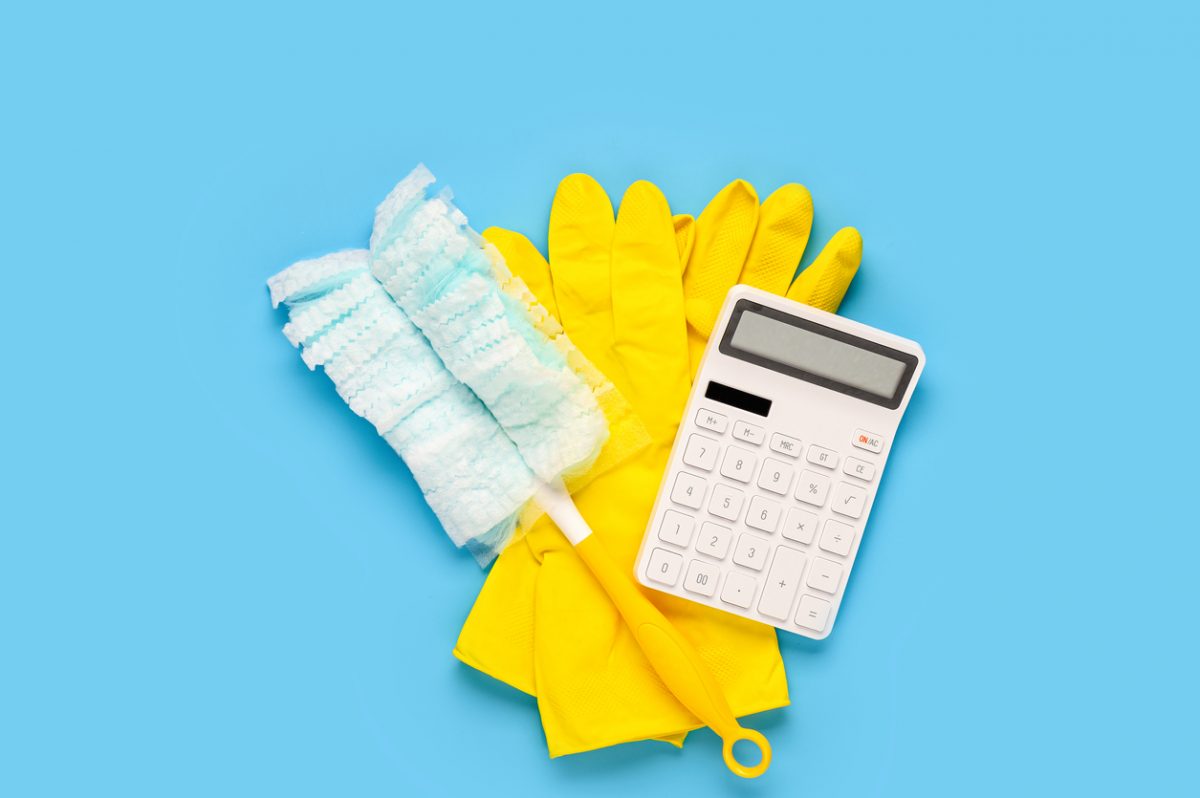Feather duster, pair of marigolds and calculator representing financial spring clean