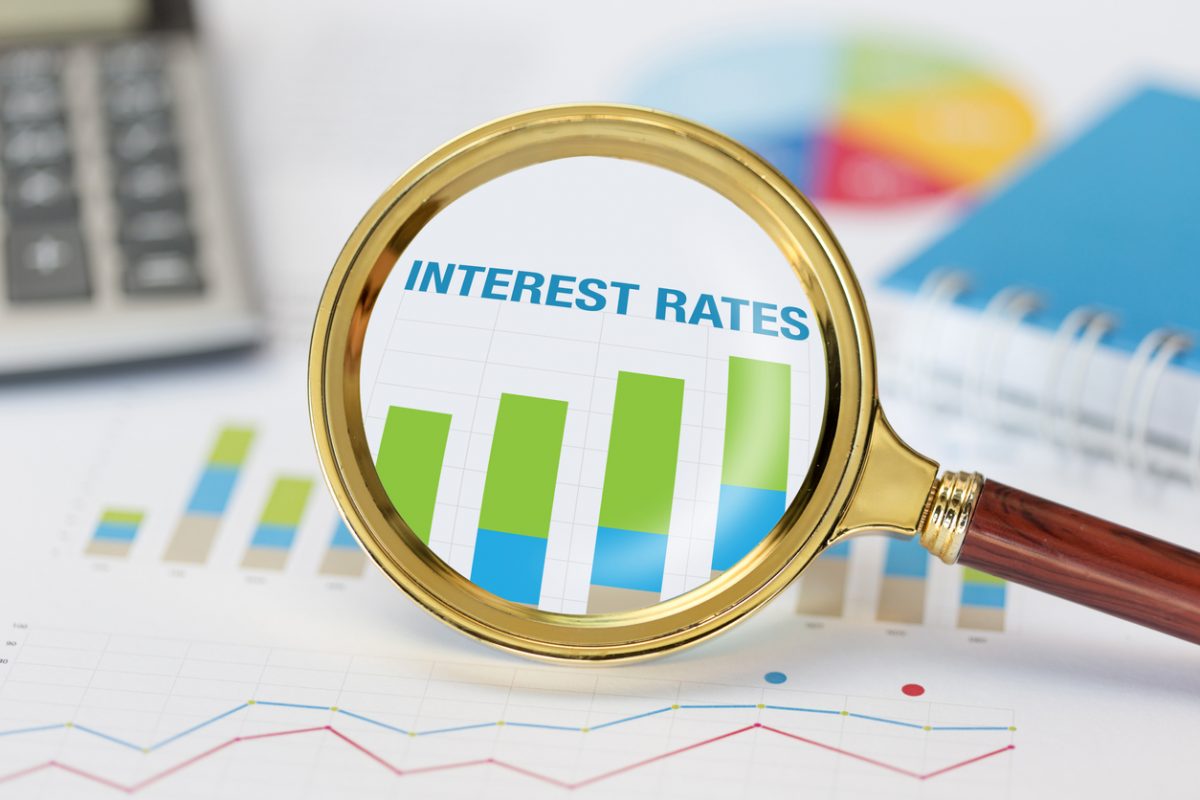 Magnifying glass over document reading 'interest rates'