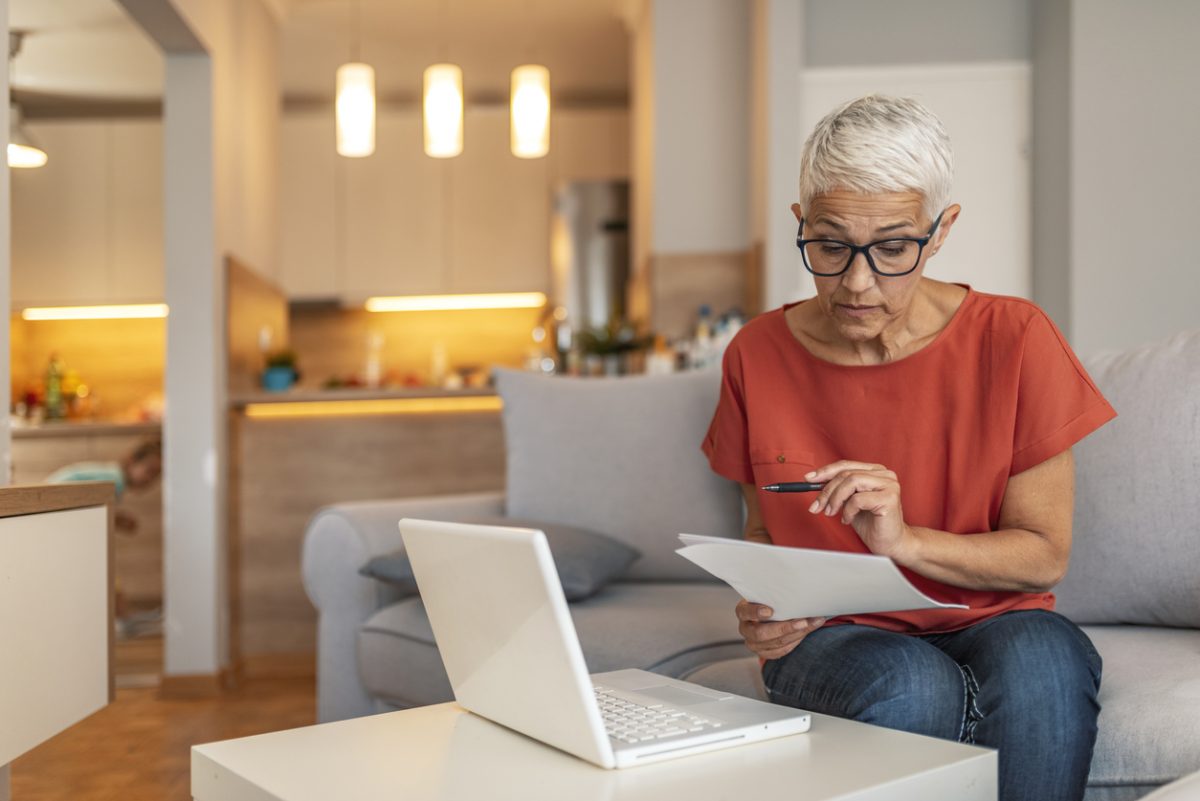 Woman reviewing pension options on laptop at home
