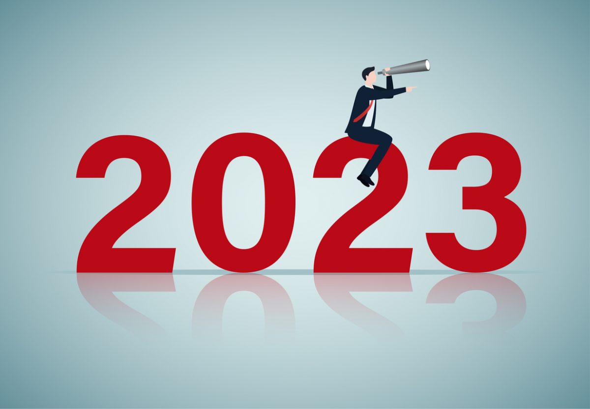 Graphic of 2023 with person sitting on it holding a telescope representing looking ahead to the new year