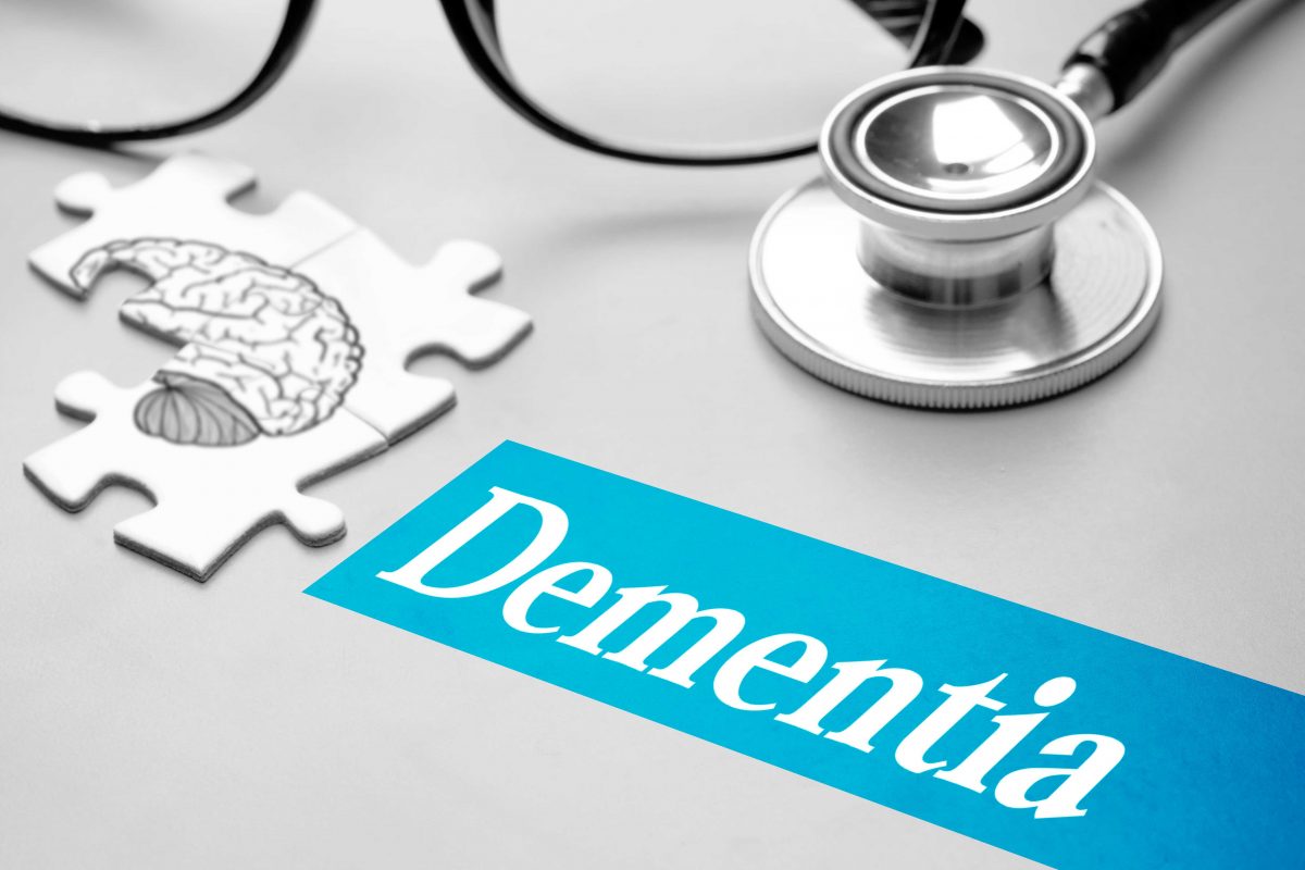 Graphic of an incomplete jigsaw of a brain, stethoscope and glasses representing dementia